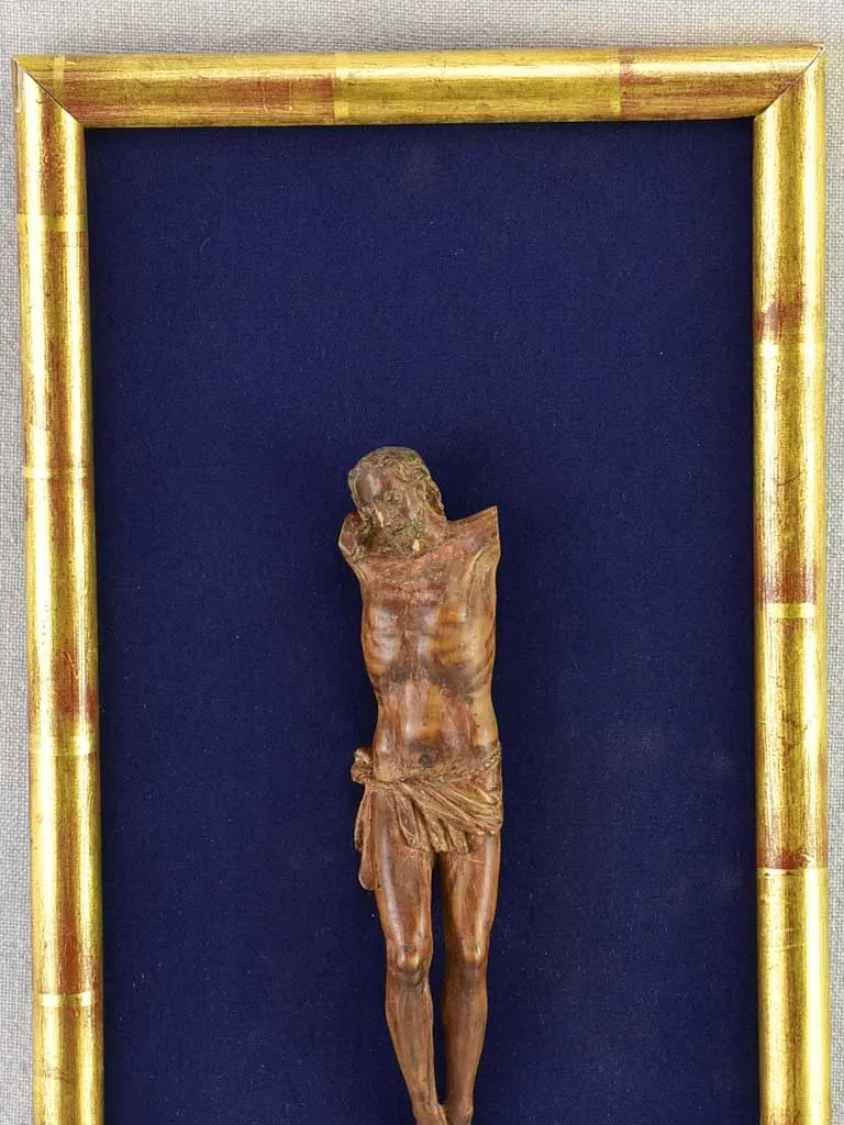 18th Century sculpture of Jesus Christ on blue fabric in gold frame