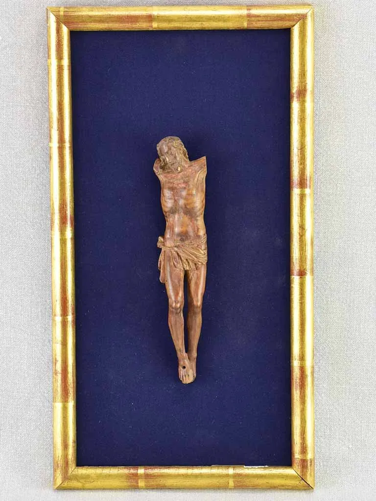 18th Century sculpture of Jesus Christ on blue fabric in gold frame