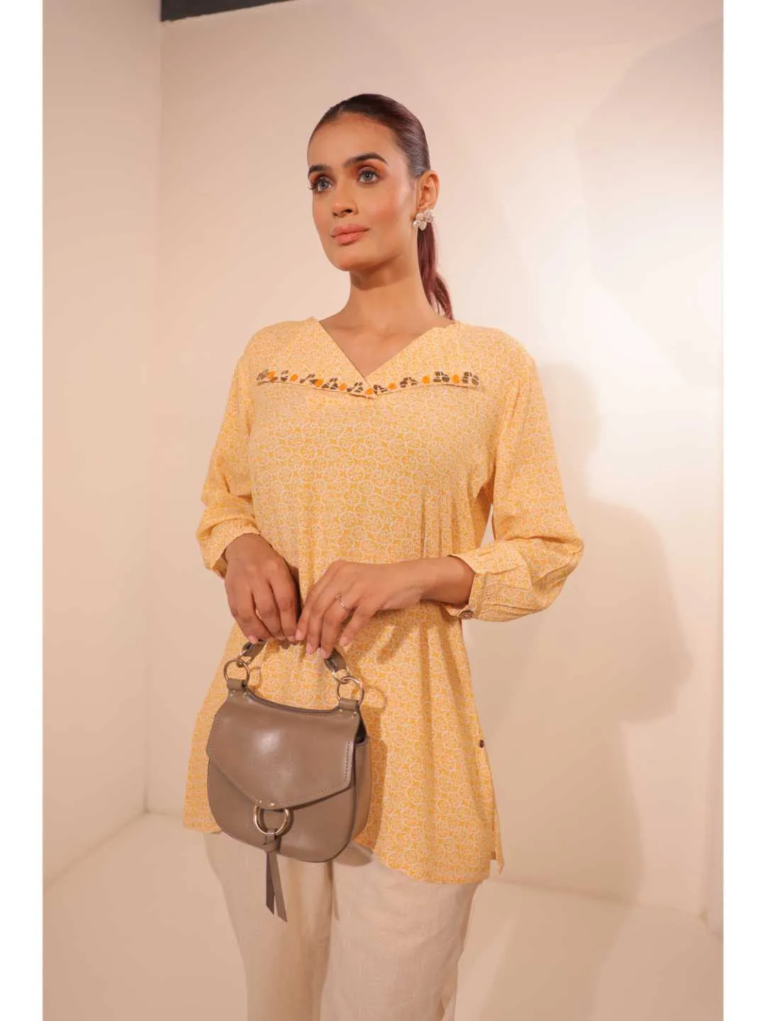 cheerful royal crepe viscose printed hand embellished overlapped V neck lapel collared,  with three fourth puff sleeve top. - Yellow