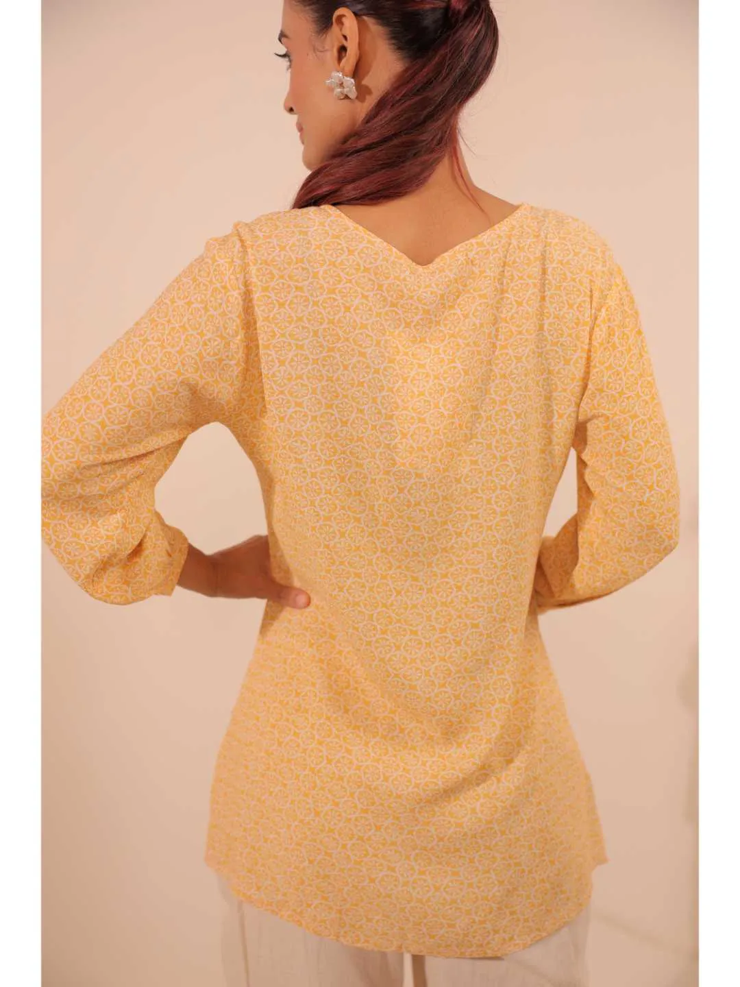 cheerful royal crepe viscose printed hand embellished overlapped V neck lapel collared,  with three fourth puff sleeve top. - Yellow