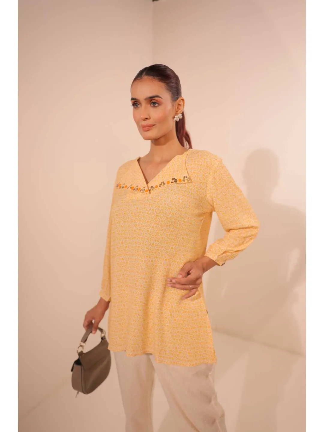 cheerful royal crepe viscose printed hand embellished overlapped V neck lapel collared,  with three fourth puff sleeve top. - Yellow