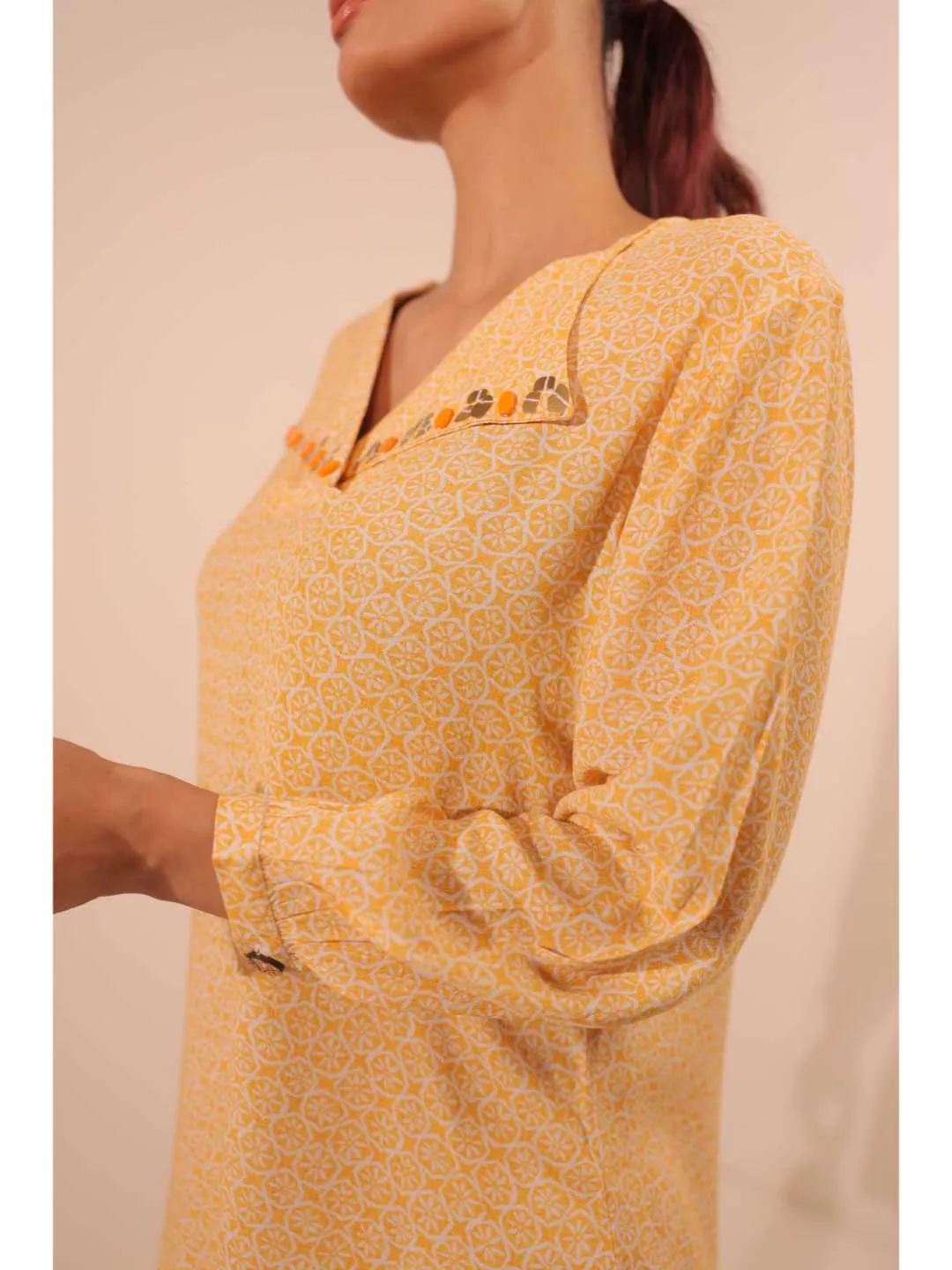 cheerful royal crepe viscose printed hand embellished overlapped V neck lapel collared,  with three fourth puff sleeve top. - Yellow